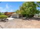 View of the exterior featuring two car garage with concrete driveway, mature landscaping and architectural features at 1419 E Las Palmaritas Dr, Phoenix, AZ 85020