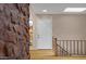 Foyer area with a white front door, hardwood floors, and a stained-glass window, with a stone column on the left at 1419 E Las Palmaritas Dr, Phoenix, AZ 85020