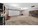 Spacious garage area with shelving units and overhead door, offering ample storage and functionality at 1419 E Las Palmaritas Dr, Phoenix, AZ 85020