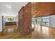 Open-concept living space features a stone fireplace, wood-paneled ceiling, hardwood floors and access to the kitchen at 1419 E Las Palmaritas Dr, Phoenix, AZ 85020