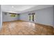 Open-concept living room featuring tile flooring, neutral paint, and access to the outside patio at 1419 E Las Palmaritas Dr, Phoenix, AZ 85020