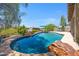Inviting pool area with rock accents and desert landscaping, offers a relaxing outdoor retreat at 1419 E Las Palmaritas Dr, Phoenix, AZ 85020