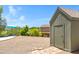 Backyard shed nestled amidst lush greenery, with a view of the pool, offering practical storage at 1419 E Las Palmaritas Dr, Phoenix, AZ 85020