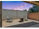 Private backyard retreat with a fire pit and patio seating, ideal for outdoor entertaining and relaxation at 14360 W Pershing St, Surprise, AZ 85379