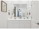 Bright bathroom featuring double sinks, a large mirror, and ample counter space at 14360 W Pershing St, Surprise, AZ 85379