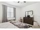 Cozy bedroom boasts neutral colors and a large window, creating a relaxing retreat at 14360 W Pershing St, Surprise, AZ 85379