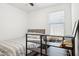 Bedroom featuring a window for natural light, a desk, and built-in shelves for storage at 14360 W Pershing St, Surprise, AZ 85379