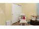 Charming Bedroom features a rocking chair, soft lighting, and ample storage with a closet at 14360 W Pershing St, Surprise, AZ 85379