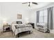 Bright bedroom with a double bed, grey accents, and a large window that provides natural light at 14360 W Pershing St, Surprise, AZ 85379