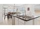 Modern kitchen with granite countertops, stainless steel appliances, and an open view to the dining area at 14360 W Pershing St, Surprise, AZ 85379