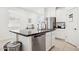 A modern kitchen features granite countertops, white cabinets, stainless steel appliances and a large island at 14360 W Pershing St, Surprise, AZ 85379