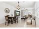 Bright living and dining space with tiled floors, a modern ceiling fan, and neutral decor at 14360 W Pershing St, Surprise, AZ 85379