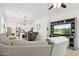 An open floor plan features a living room, kitchen and dining area, with neutral colors at 14360 W Pershing St, Surprise, AZ 85379