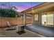 Cozy covered patio featuring a fire pit, seating area, and outdoor lighting, perfect for relaxing evenings at 14360 W Pershing St, Surprise, AZ 85379