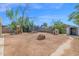 Expansive backyard with playset, trampoline, brick fire pit, and playhouse for outdoor enjoyment at 14808 N 37Th Way, Phoenix, AZ 85032
