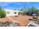 Large backyard view highlighting the home exterior, trampoline, playset, and playhouse at 14808 N 37Th Way, Phoenix, AZ 85032