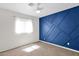 Comfortable bedroom features carpet and blue accent wall at 14808 N 37Th Way, Phoenix, AZ 85032