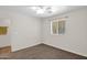 Carpeted bedroom with natural light from the window and ceiling fan for comfort at 14808 N 37Th Way, Phoenix, AZ 85032