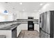 Modern kitchen boasting white cabinetry, stainless steel appliances, and sleek countertops at 14808 N 37Th Way, Phoenix, AZ 85032
