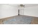 Spacious living room with tile floors, ceiling fan, and neutral decor with a door to the laundry room at 14808 N 37Th Way, Phoenix, AZ 85032