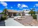 Expansive backyard with desert landscaping, covered patio, and a water fountain at 15194 W Vale Dr, Goodyear, AZ 85395
