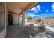 Covered backyard patio with seating and a water fountain feature at 15194 W Vale Dr, Goodyear, AZ 85395