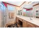 Bathroom with a double sink vanity, large mirror, and separate shower and tub at 15194 W Vale Dr, Goodyear, AZ 85395