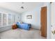 Cozy bedroom featuring a ceiling fan, plantation shutters, and carpet flooring at 15194 W Vale Dr, Goodyear, AZ 85395