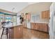 Bright eat-in kitchen featuring an island, light wood cabinetry, and tile flooring at 15194 W Vale Dr, Goodyear, AZ 85395