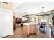 Open-concept kitchen boasts an island, casual dining space, and seamless flow to living area at 15194 W Vale Dr, Goodyear, AZ 85395