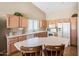 Functional kitchen featuring ample counter space, wood cabinetry, and white appliances for a clean look at 15194 W Vale Dr, Goodyear, AZ 85395