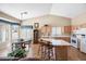 Eat-in kitchen with a center island, wooden cabinets, and breakfast nook with large windows at 15194 W Vale Dr, Goodyear, AZ 85395