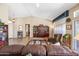 Cozy living room featuring comfortable seating, warm lighting, and seamless flow into the kitchen area at 15194 W Vale Dr, Goodyear, AZ 85395