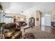 Bright and airy living room with a vaulted ceiling, plush furniture, and tile flooring at 15194 W Vale Dr, Goodyear, AZ 85395