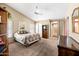 Large bedroom with a ceiling fan, walk-in closet and en-suite bathroom at 15194 W Vale Dr, Goodyear, AZ 85395