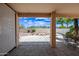 Covered patio area with view to the backyard and community beyond a wall at 15194 W Vale Dr, Goodyear, AZ 85395