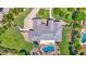 Aerial view of a home with a well-maintained roof, lush landscaping, and a refreshing pool in the backyard at 1940 N Stevens Cir, Mesa, AZ 85205