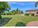 Lush, expansive backyard features a manicured lawn, privacy landscaping, and ample space for recreation at 1940 N Stevens Cir, Mesa, AZ 85205