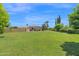 Expansive backyard with a well-maintained lawn and privacy landscaping offers plenty of space for outdoor activities at 1940 N Stevens Cir, Mesa, AZ 85205