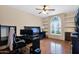 Bedroom with hardwood floors, a ceiling fan, and a dark wood bed frame with built-ins at 1940 N Stevens Cir, Mesa, AZ 85205