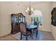 Elegant dining room features a decorative chandelier and a large window at 1940 N Stevens Cir, Mesa, AZ 85205