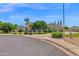 Beautiful single-Gathering home featuring mature trees, lush landscaping, and a circular driveway at 1940 N Stevens Cir, Mesa, AZ 85205