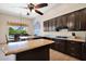 Bright kitchen features an island, granite countertops, and stainless steel appliances at 1940 N Stevens Cir, Mesa, AZ 85205