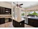 Beautiful kitchen with granite counters, a center island, and backyard views at 1940 N Stevens Cir, Mesa, AZ 85205
