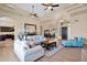 Spacious living room boasts wood floors, coffered ceilings, and comfortable seating at 1940 N Stevens Cir, Mesa, AZ 85205