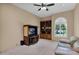 Comfortable living room with a tv, built in shelving and cabinetry, and a leather couch at 1940 N Stevens Cir, Mesa, AZ 85205