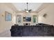 Spacious living room featuring a large comfortable couch, recessed lighting and modern ceiling fan at 1940 N Stevens Cir, Mesa, AZ 85205