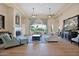 Elegant living room with high ceilings, a cozy fireplace, large windows, and stylish furnishings at 1940 N Stevens Cir, Mesa, AZ 85205