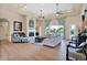 Inviting living room featuring a fireplace, comfortable seating, large windows, and wood floors at 1940 N Stevens Cir, Mesa, AZ 85205