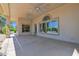 Covered patio with ceiling fans and large windows overlooking the lush backyard and pool area at 1940 N Stevens Cir, Mesa, AZ 85205